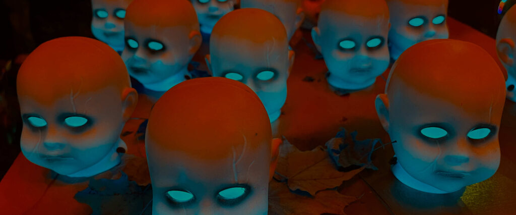 Surreal artwork detail: glowing cyan baby heads from the screen print 'Another Visit From the Glowing Baby Heads